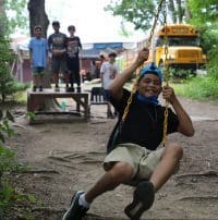 Smiling boy on outdoor rope swing
