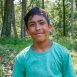 Smiling boy in teal shirt outdoors
