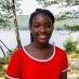 Smiling girl in red shirt by lake