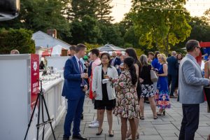 Guests mingling at outdoor cocktail party