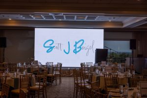 Banquet hall with round tables and large screen
