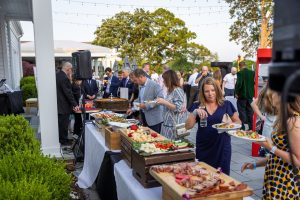 Guests serving themselves at outdoor buffet