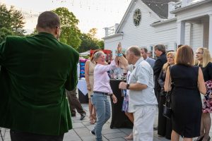 Guests high-fiving at outdoor patio party