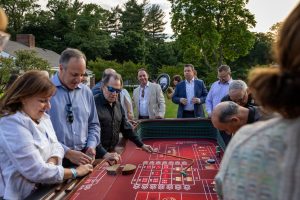 People gathered around outdoor craps table