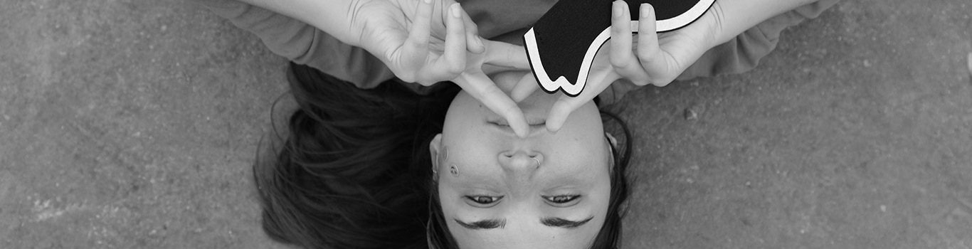 Woman lying holding speech bubble and peace sign