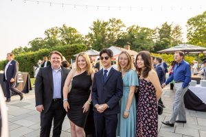 Young adults in formal attire at outdoor reception