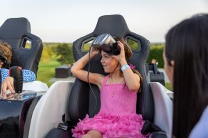 Girl wearing VR headset on ride seat