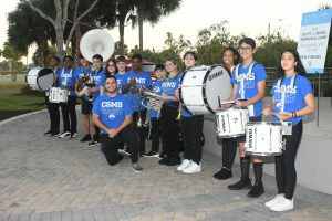 Middle school marching band posing with instruments