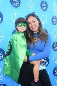 Woman and child dressed as superheroes smiling