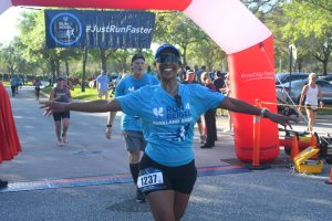 Smiling runner crossing race finish line