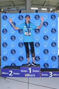 Runner celebrating on first-place podium