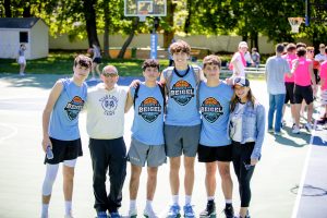 Teen basketball players posing on outdoor court