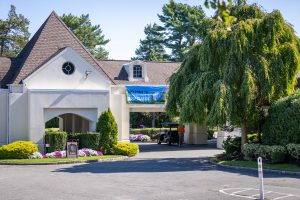 Clubhouse entrance with banner and landscaping