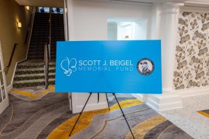 Blue memorial sign on easel in lobby