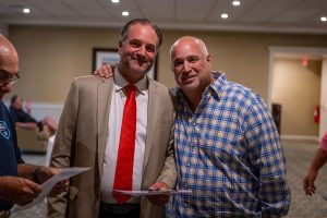 Two men smiling and posing together