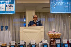 Person speaking at podium during fundraiser